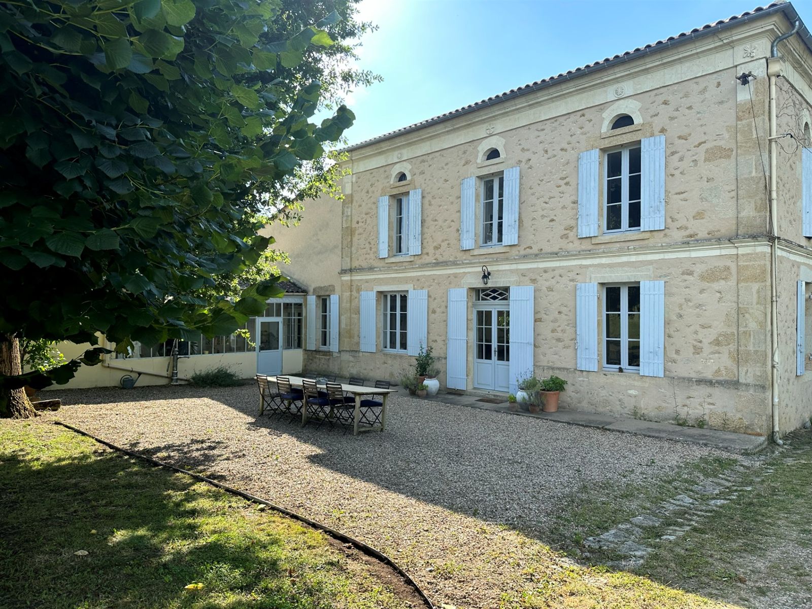 The principal stone facade and gravel terrace