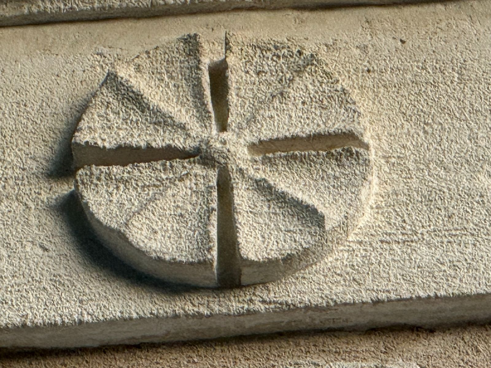 Carved circular stone detail divided into four sections